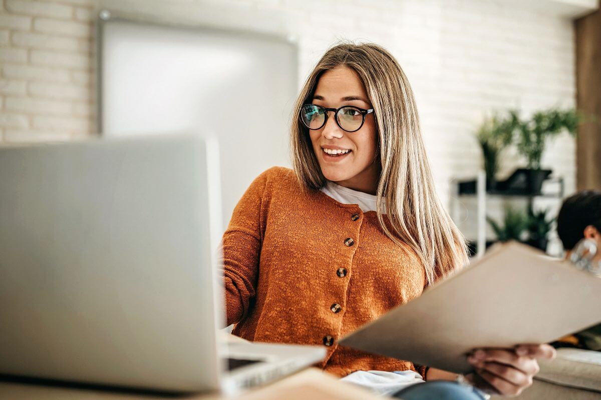 An image shows a woman using a laptop.