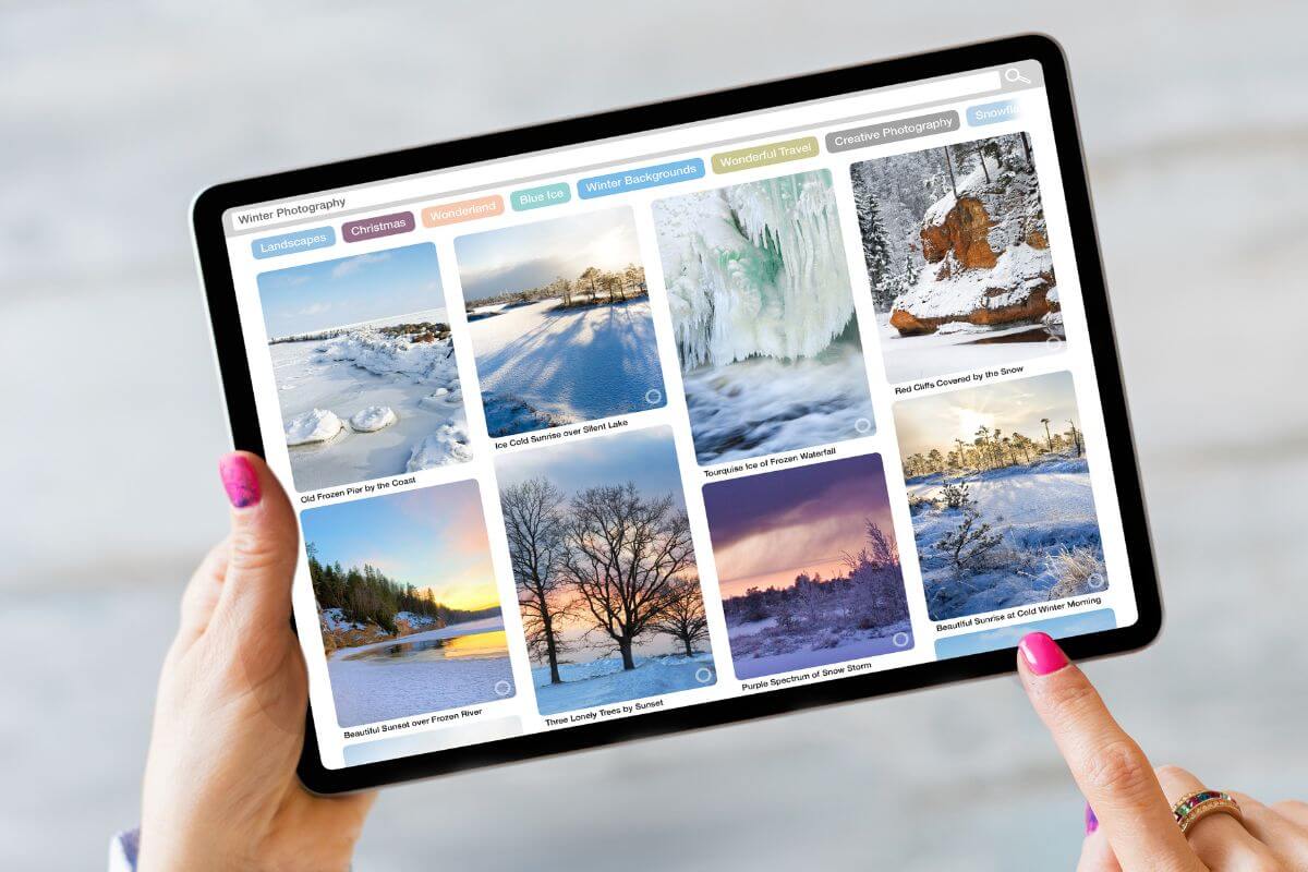 A picture of a woman's hand using a tablet device.