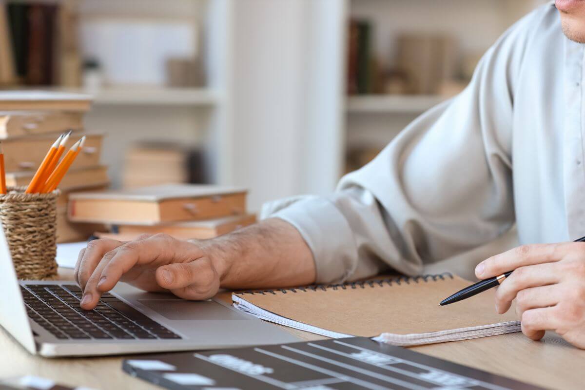 An image shows a man working on a laptop.