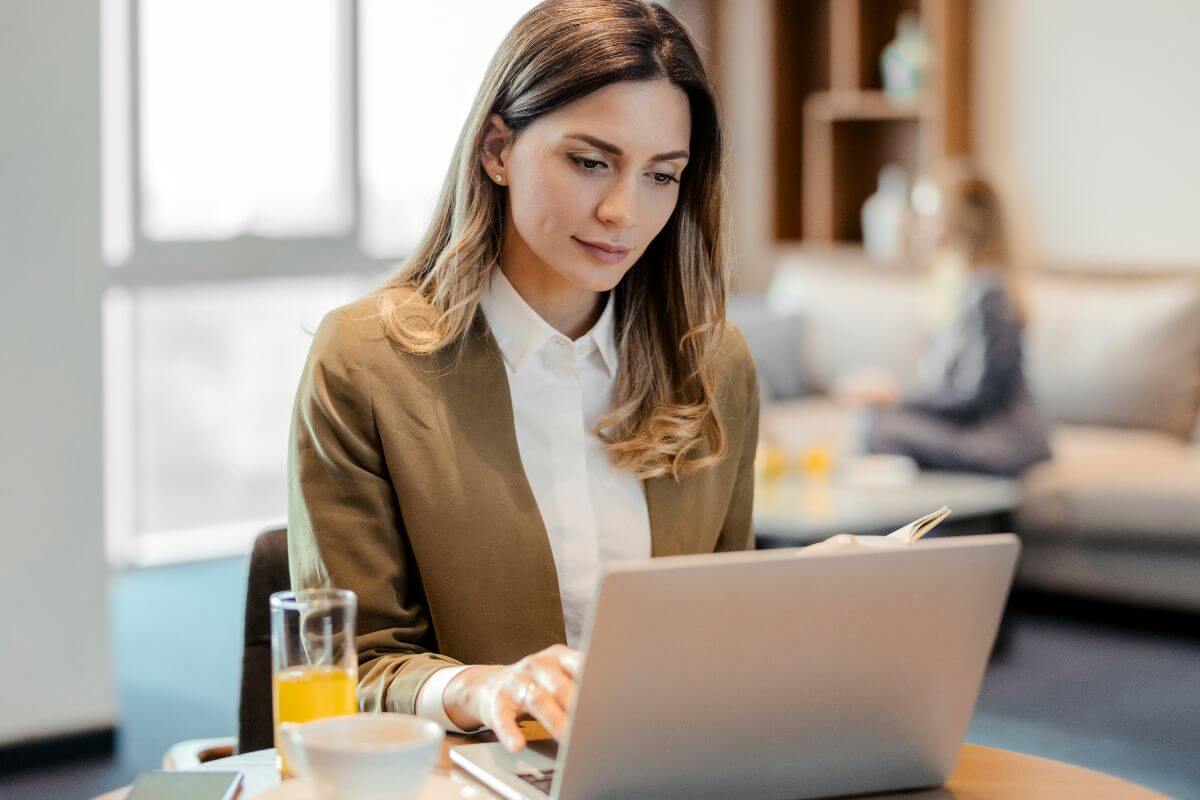 A picture of a woman working on a laptop.
