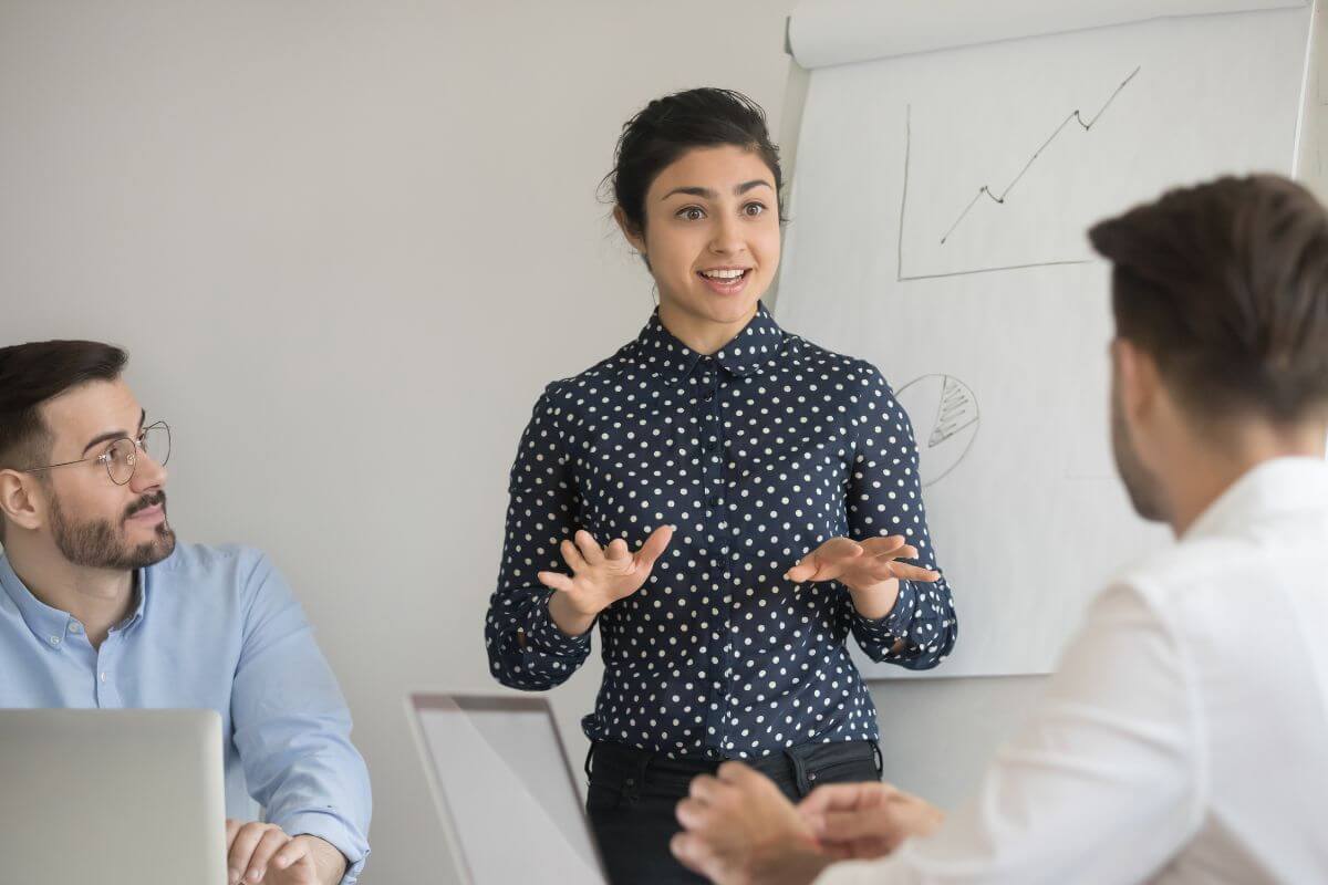 A picture shows employees in a meeting.