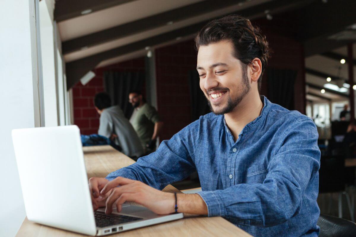 A picture of a man using a laptop.