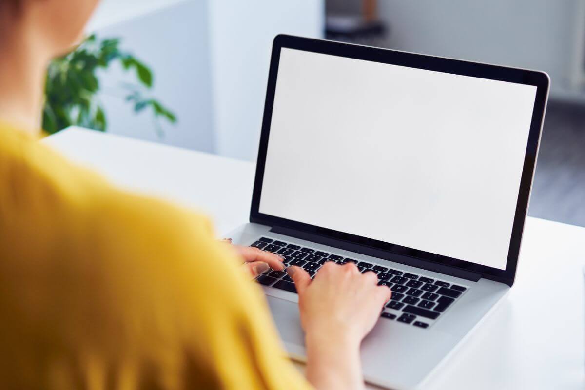A picture of a woman using a laptop.