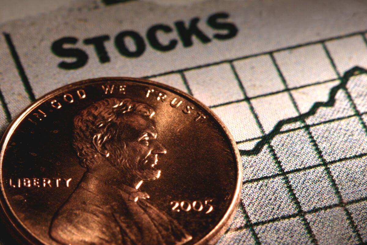 An image shows a coin and Stocks graph.