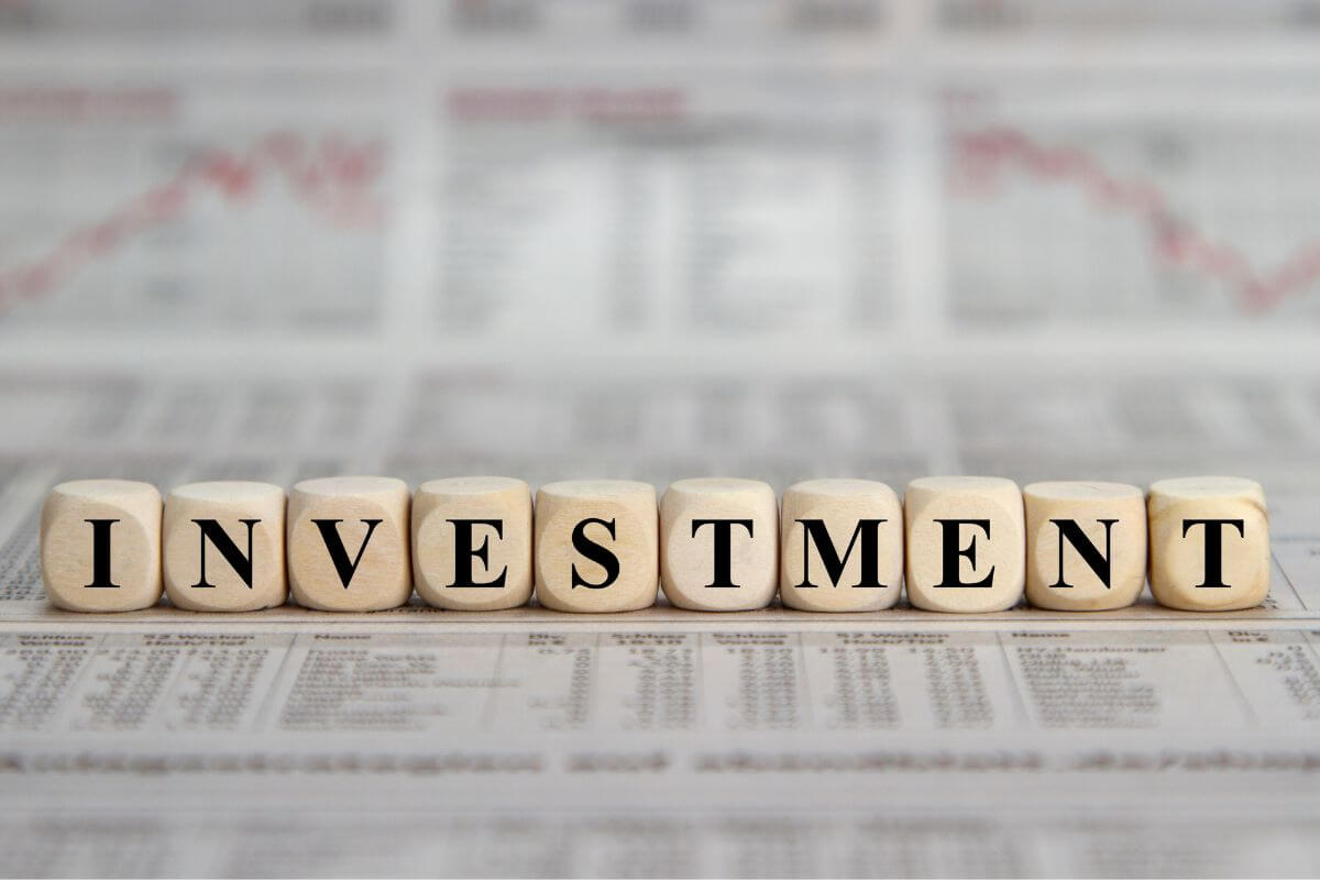 A picture of an investment wording on wooden cubes.