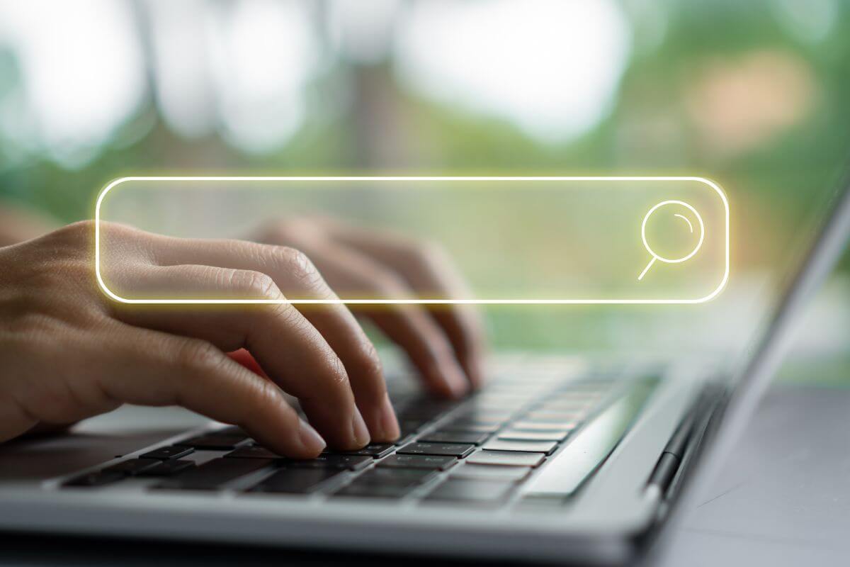 An image of a woman's hand searching something online.