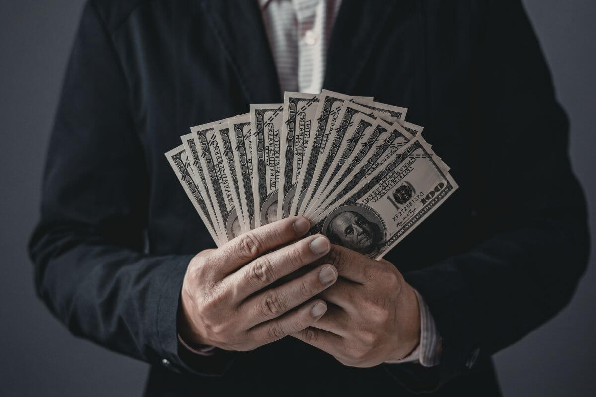 A picture shows a man holding money.