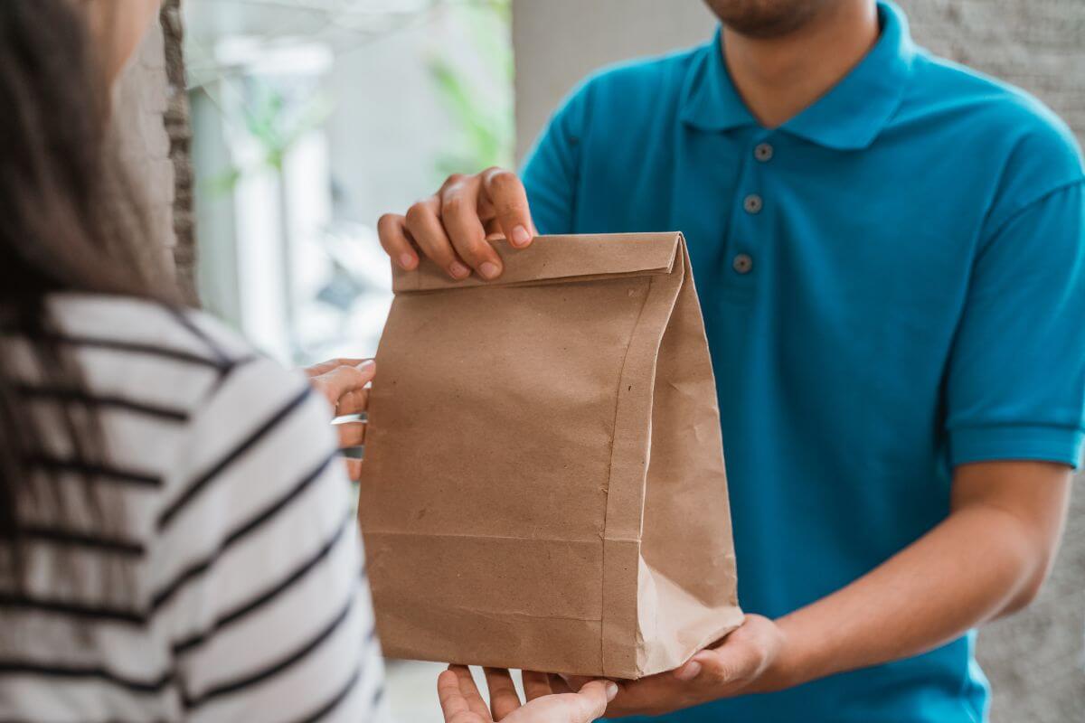 A picture shows a man delivering food.