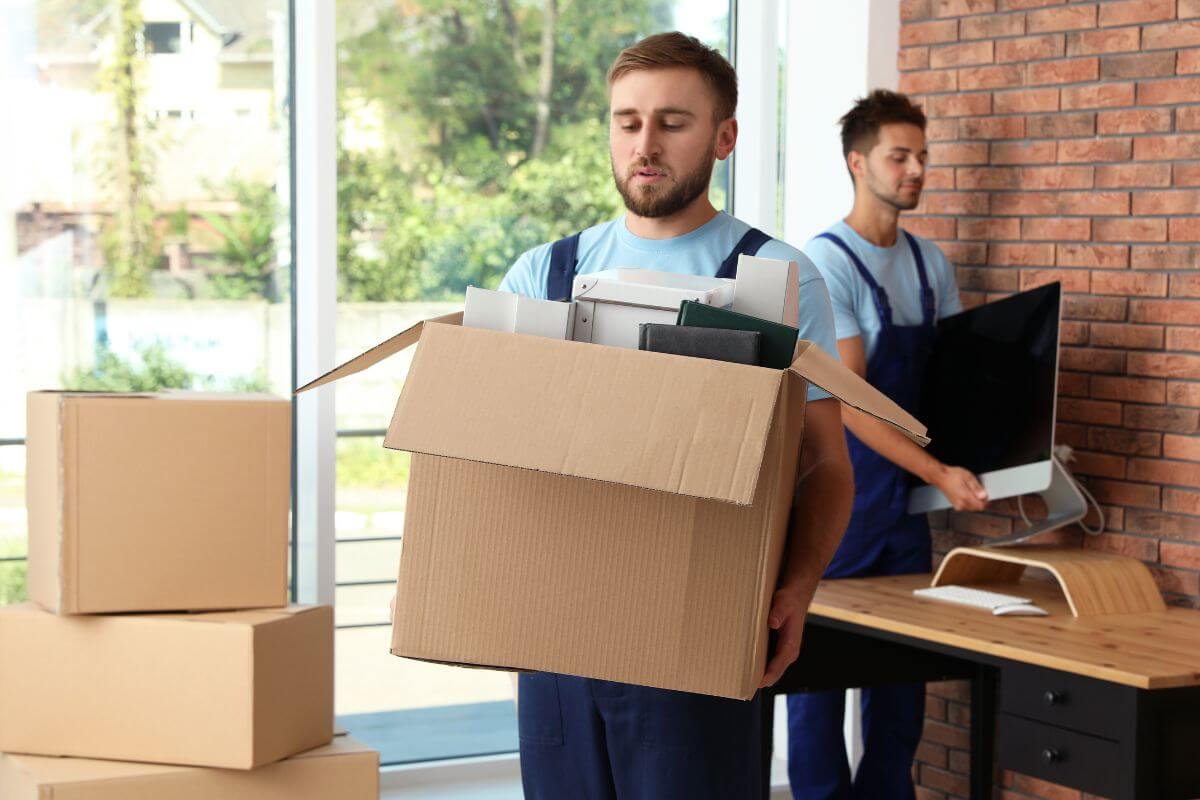 A picture shows men moving out the stuff into the box.
