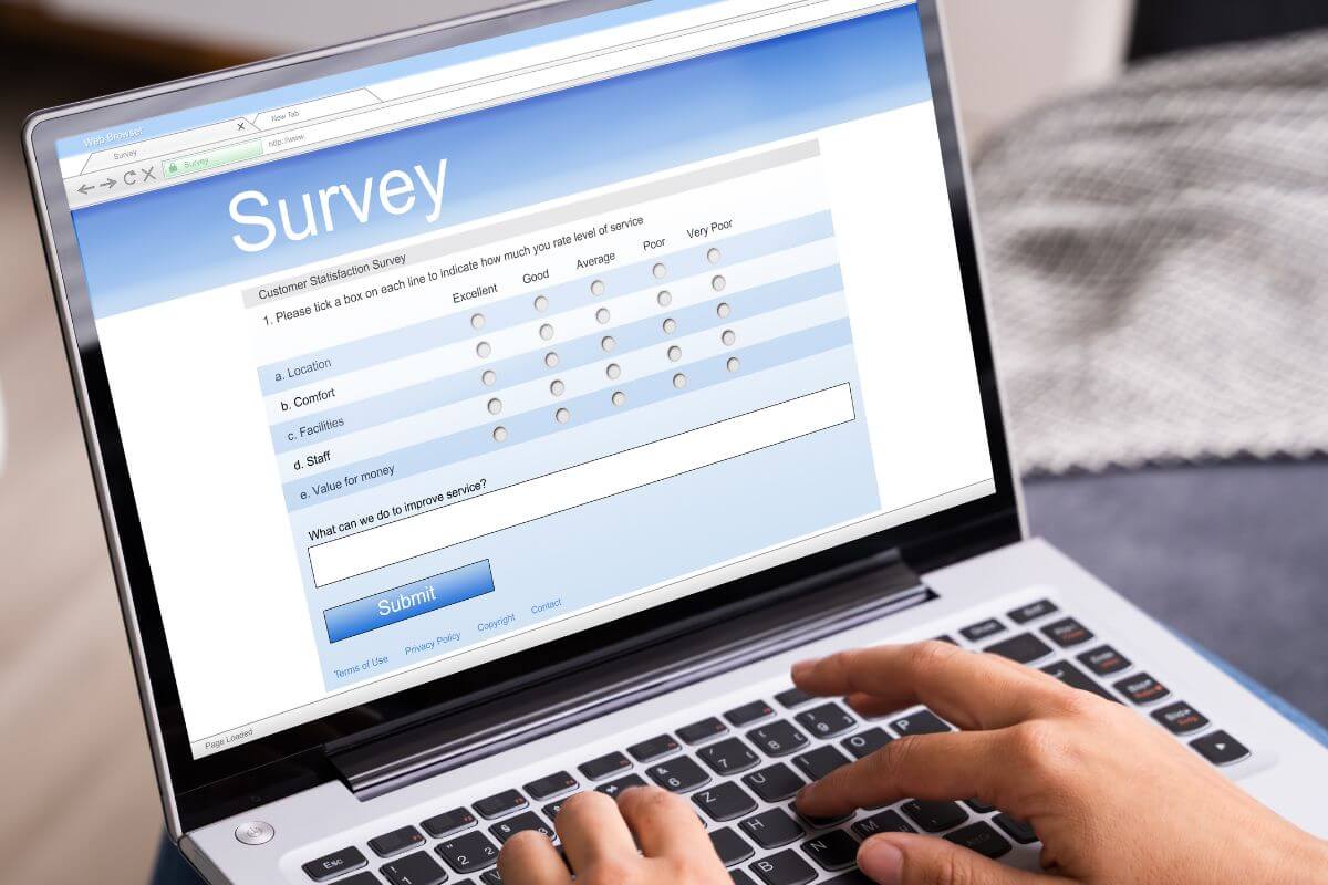 An image of a woman's hand taking an online survey.