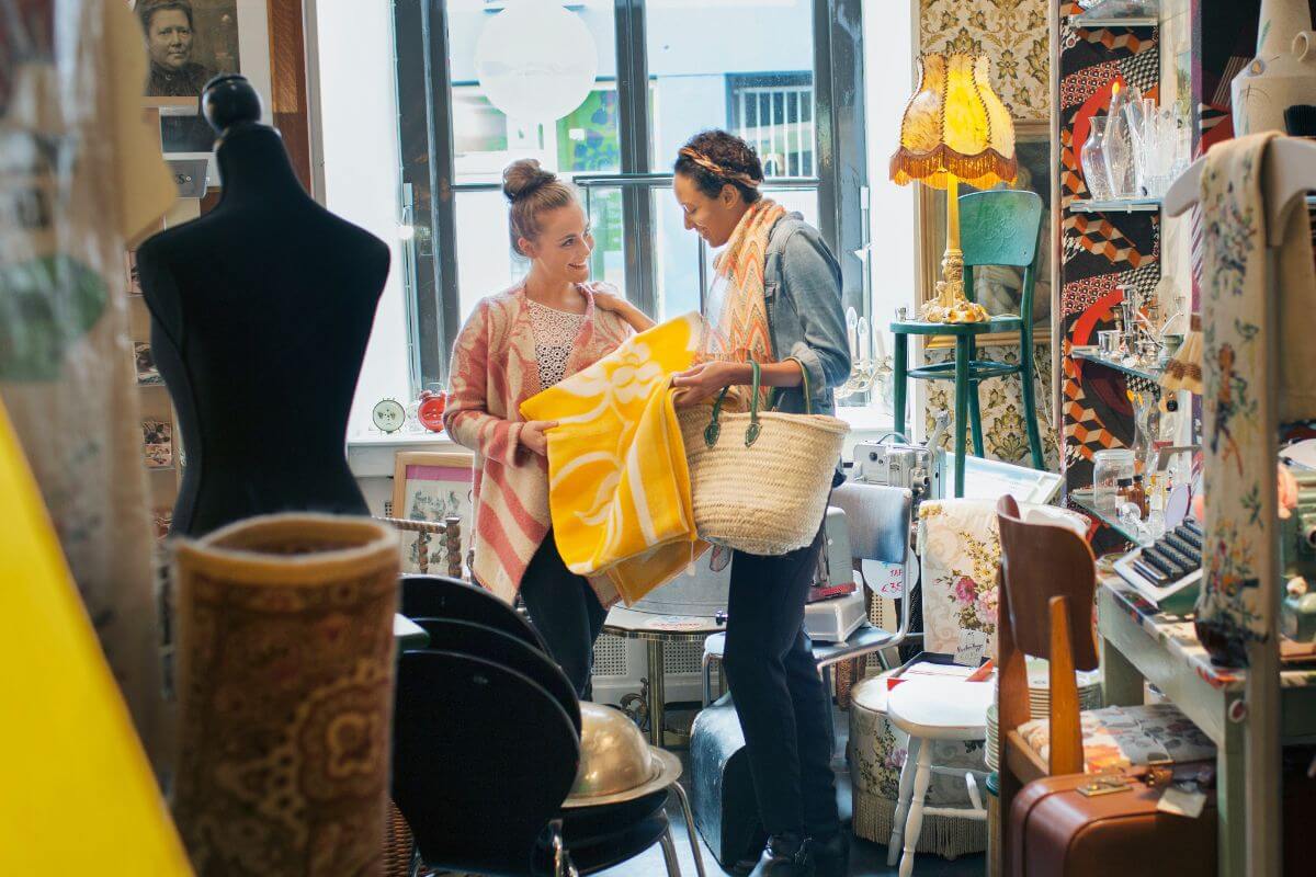 A picture of women at the thrift shop finding some stuff.