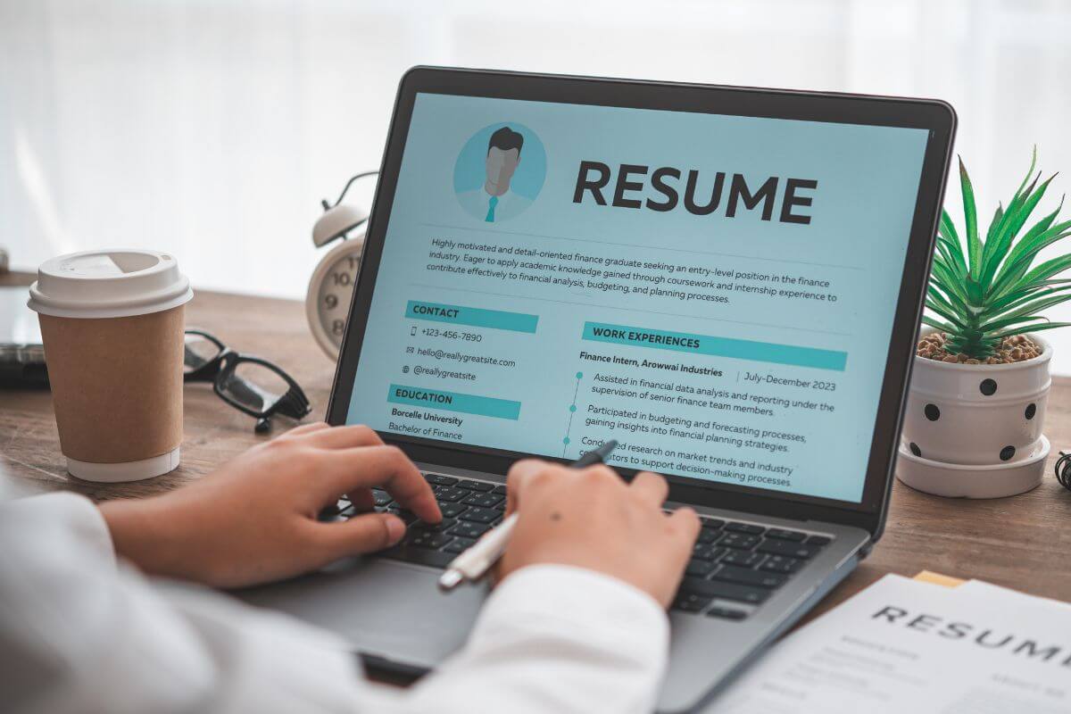 A picture of a man's hand editing a resume.