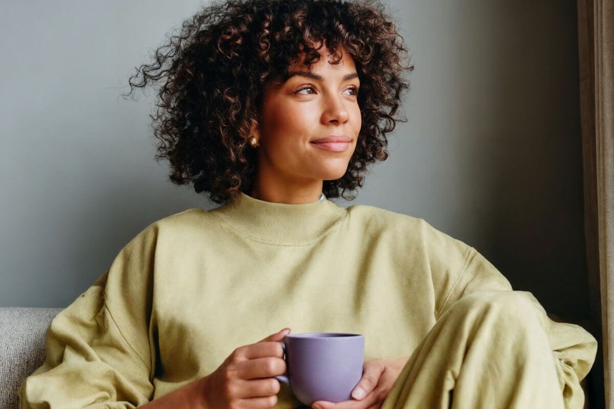 A picture of a woman having a coffee.