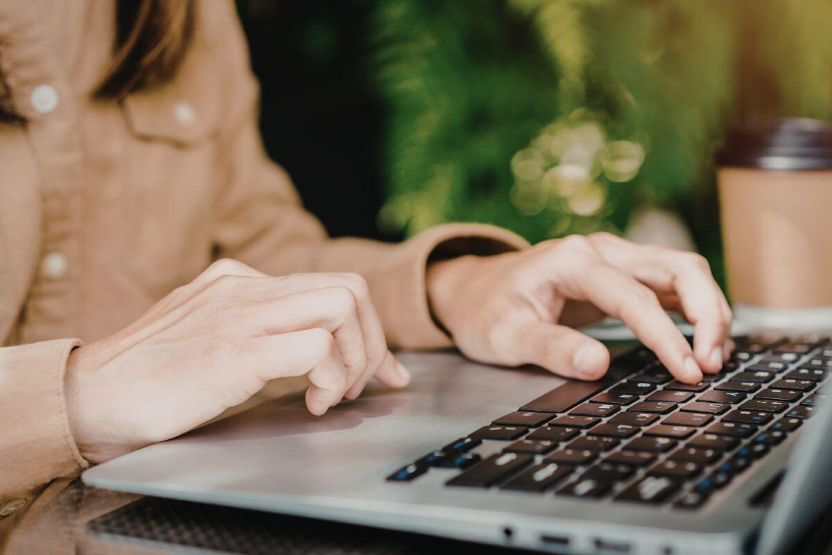 A picture of a woman using a laptop.