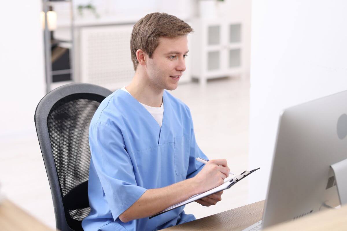 A photo of a man working as a medical assistant.