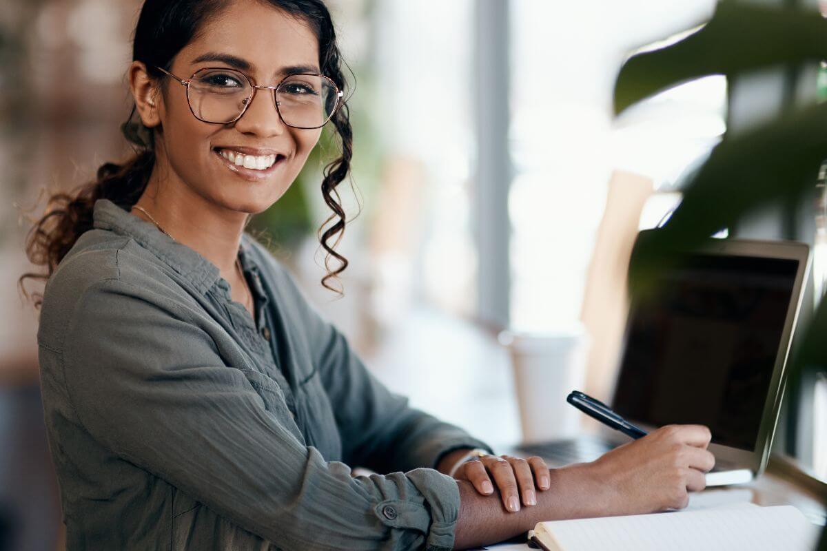 A photo of a woman using a laptop.