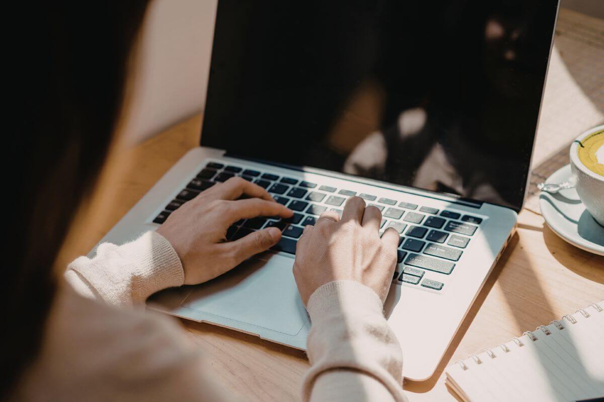 An image shows a woman using a laptop.
