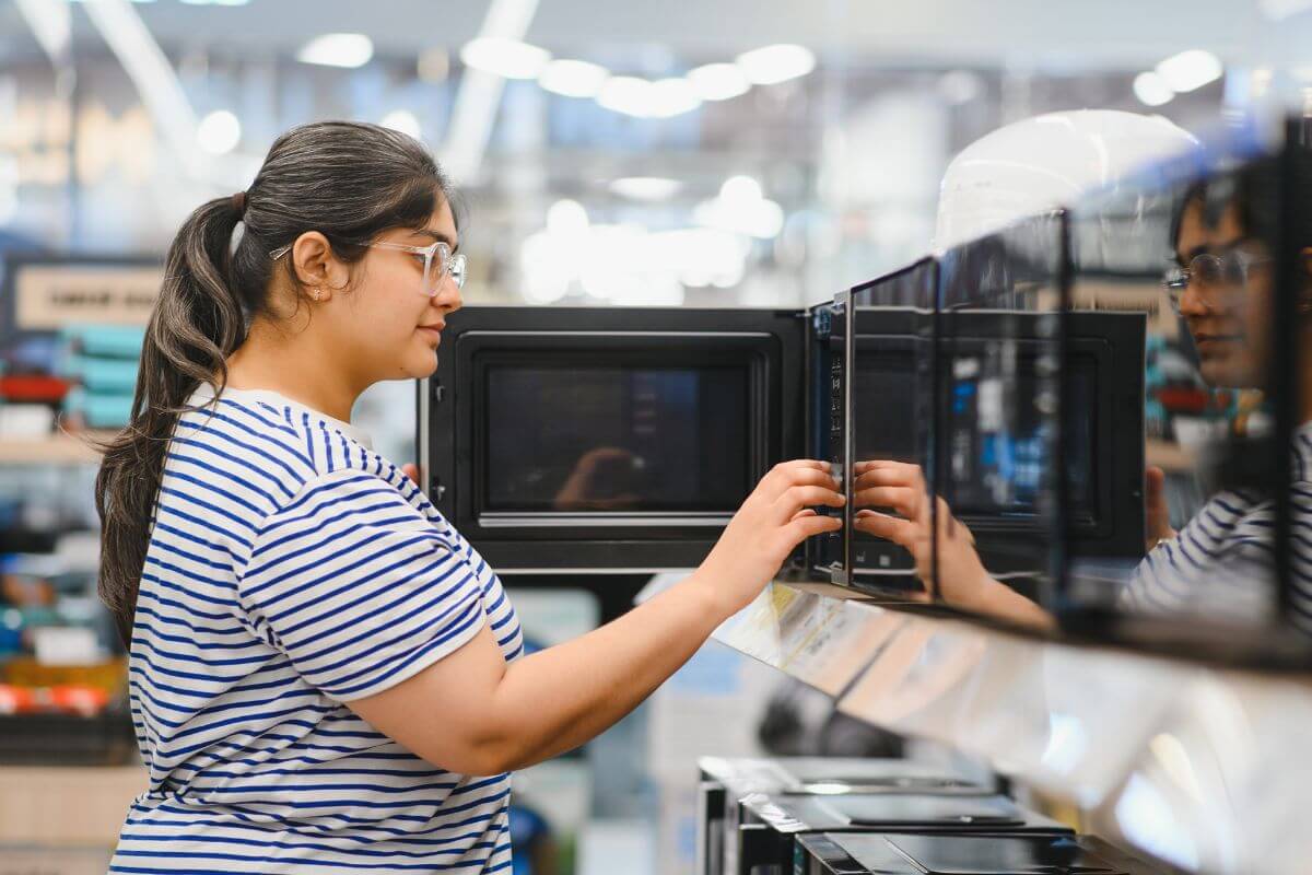 An image of a woman shopping for appliances.