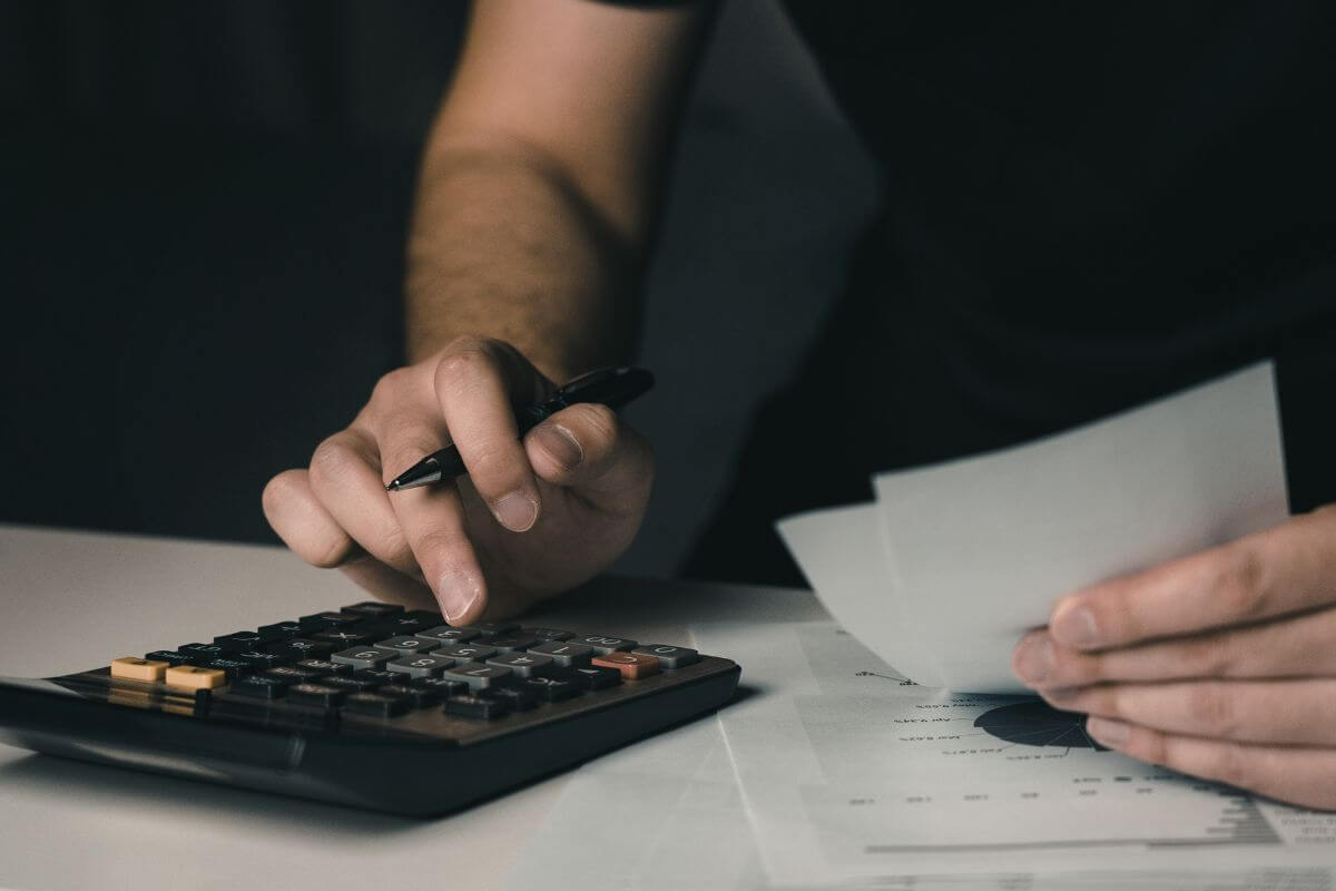 A picture of a man calculating his expenses.