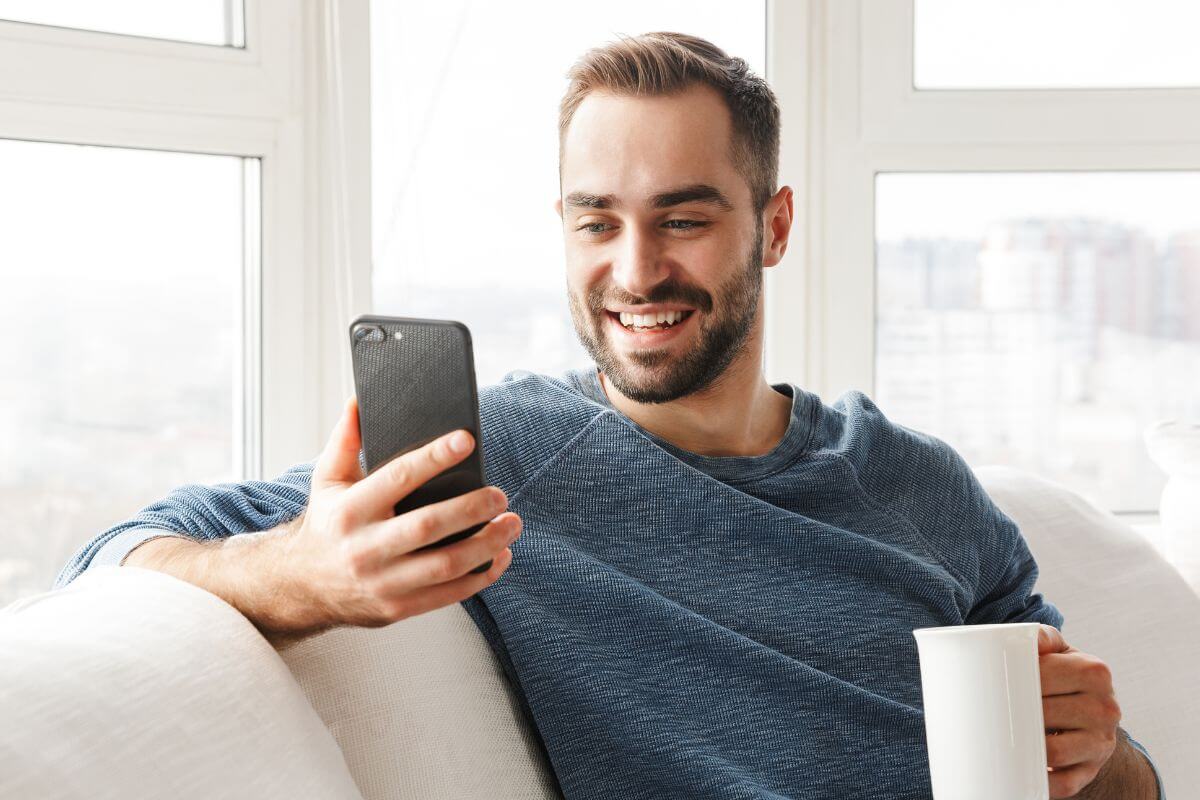 An image shows a man using a phone.