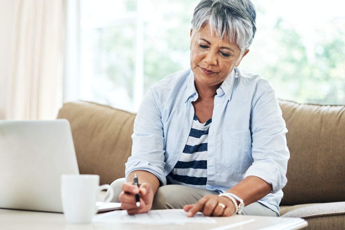 A picture of a senior woman reviewing a document.