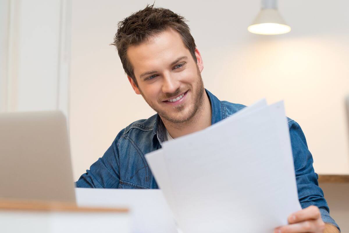 A picture shows a man reviewing some documents.