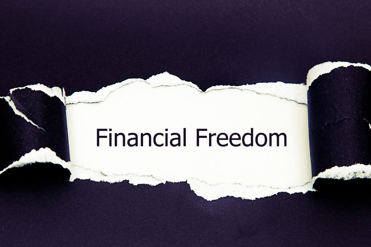 An image shows a torn paper with financial freedom wording.