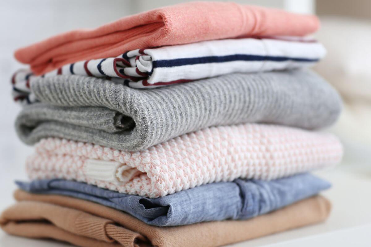 An image shows a pile of clothes on the table.