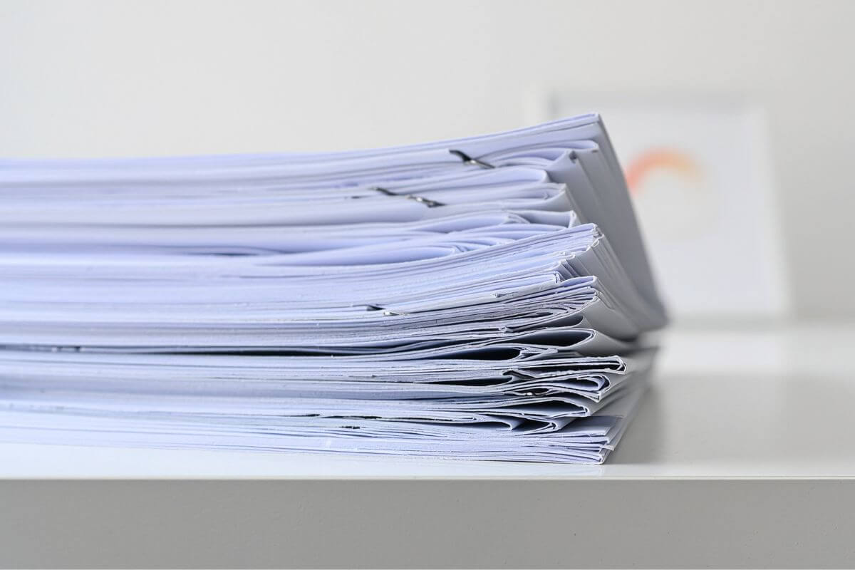A picture shows a pile of papers on the table.