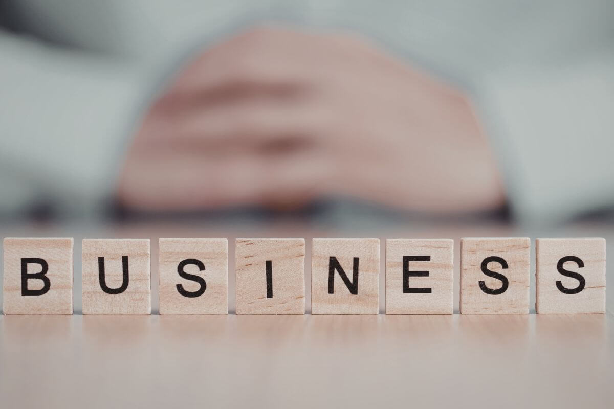 An image shows a business spelled on wooden blocks.